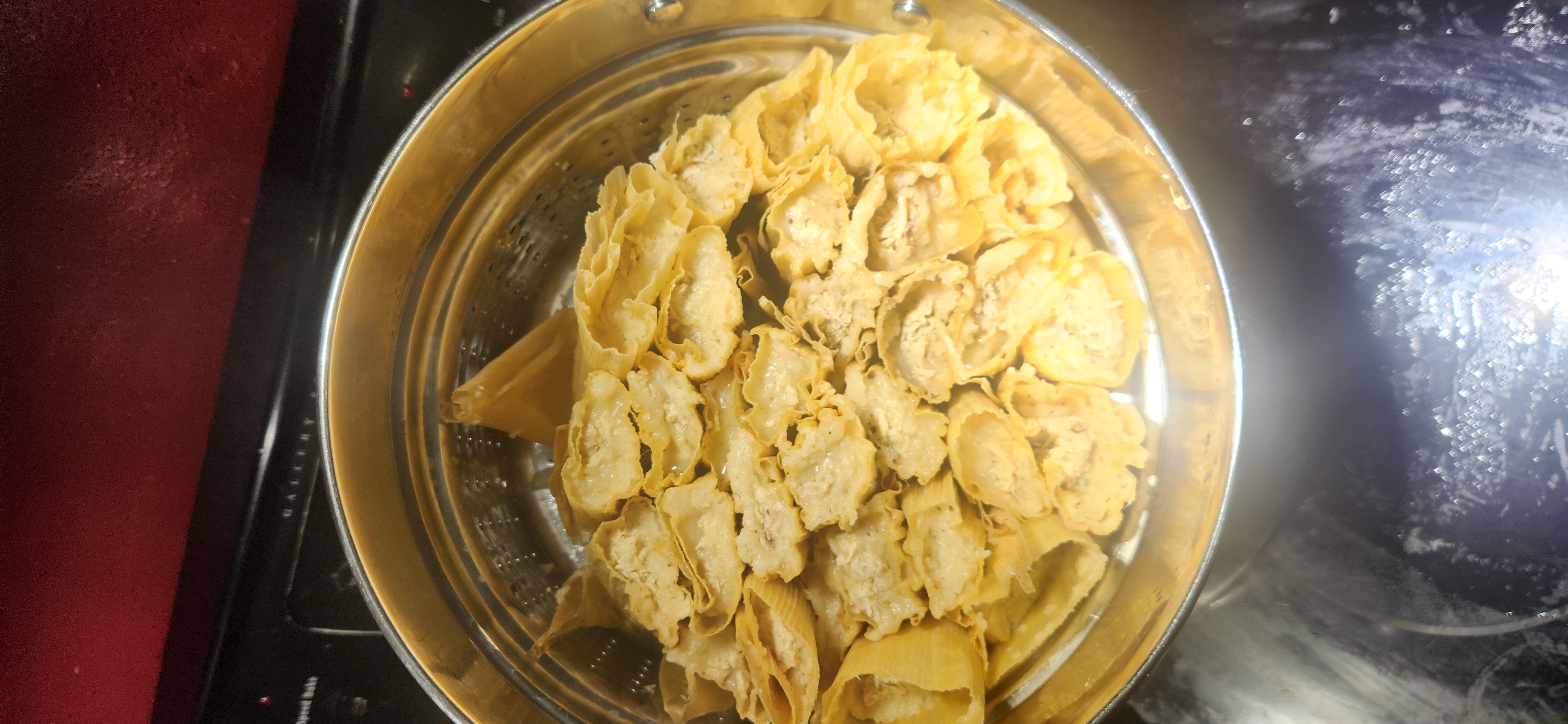 Steaming tamales in a large pot