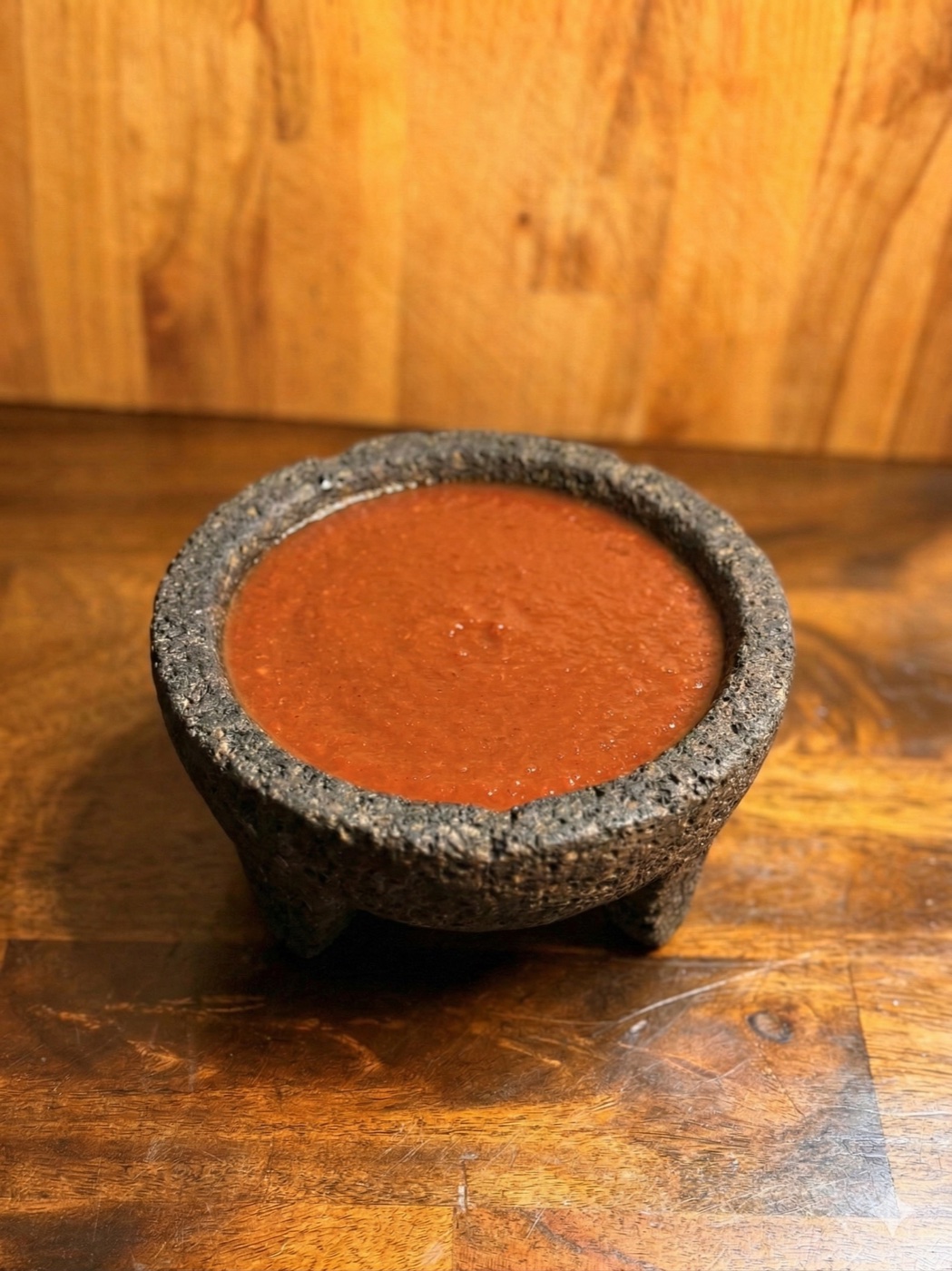 Salsa roja served in a volcanic stone molcajete